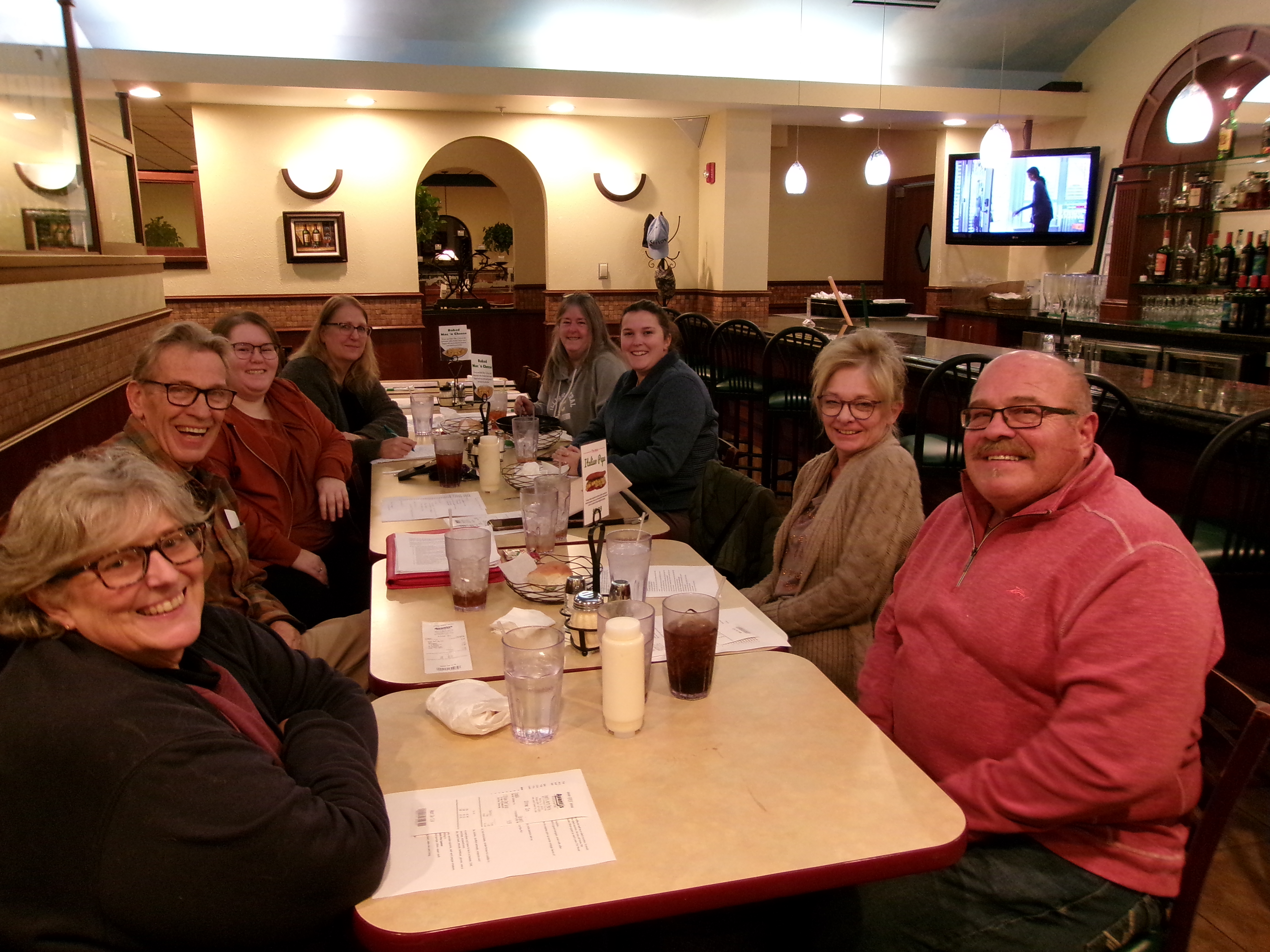 group of people sitting at a restaurant table